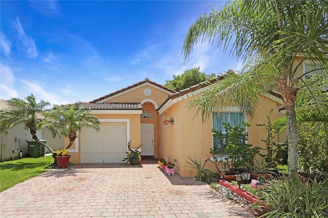1585 SE 20th Rd, Homestead, FL 33035 - mediterranean / spanish-style home with stucco siding, decorative driveway, a garage, and a tile roof