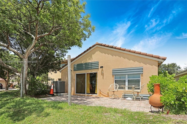 1585 SE 20th Rd, Homestead, FL 33035 - back of house with stucco siding, a patio area, and a tiled roof