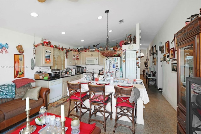 1585 SE 20th Rd, Homestead, FL 33035 - kitchen with white appliances, cream cabinets, recessed lighting, dark speckled floor, and a center island
