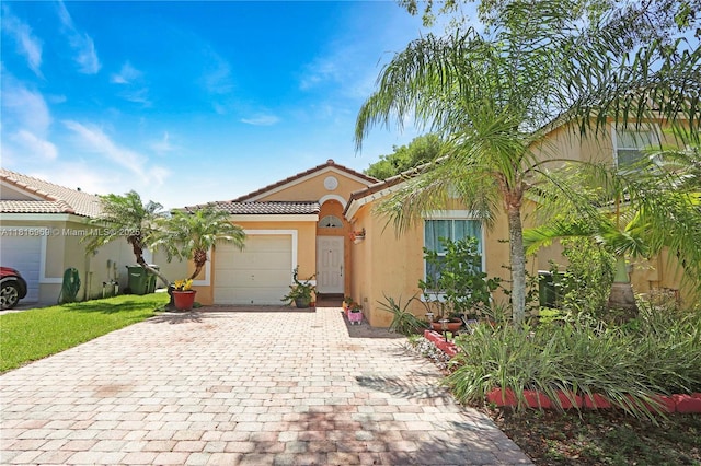 1585 SE 20th Rd, Homestead, FL 33035 - view of front of property featuring stucco siding, decorative driveway, a garage, and a tile roof