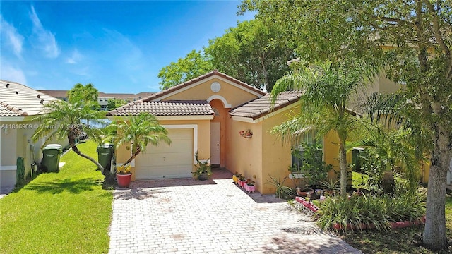 1585 SE 20th Rd, Homestead, FL 33035 - view of front of home featuring decorative driveway, an attached garage, a tiled roof, stucco siding, and a front yard