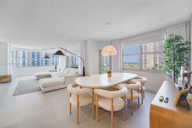 1965 S Ocean Dr Unit 6F, Hallandale Beach, FL 33009 - dining space featuring healthy amount of natural light, a textured ceiling, and light tile patterned flooring