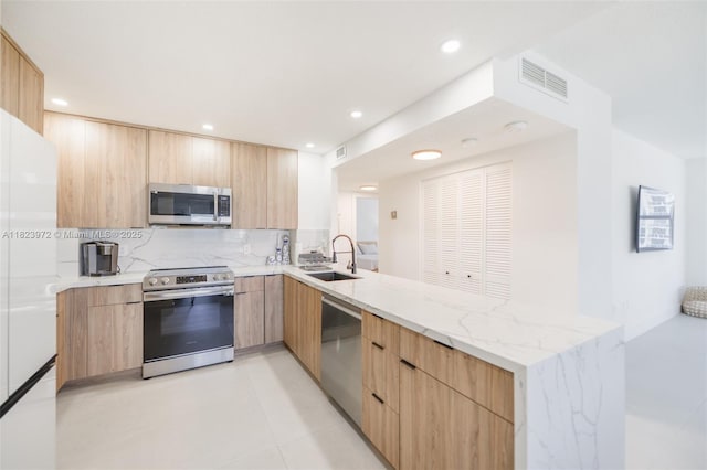 1965 S Ocean Dr Unit 6F, Hallandale Beach, FL 33009 - kitchen with appliances with stainless steel finishes, light brown cabinets, modern cabinets, and recessed lighting
