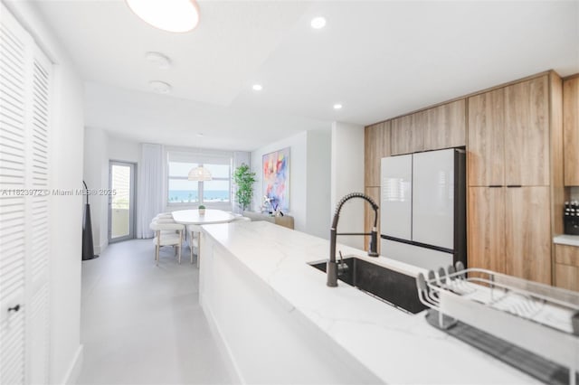 1965 S Ocean Dr Unit 6F, Hallandale Beach, FL 33009 - kitchen featuring modern cabinets, freestanding refrigerator, light stone counters, recessed lighting, and light brown cabinets