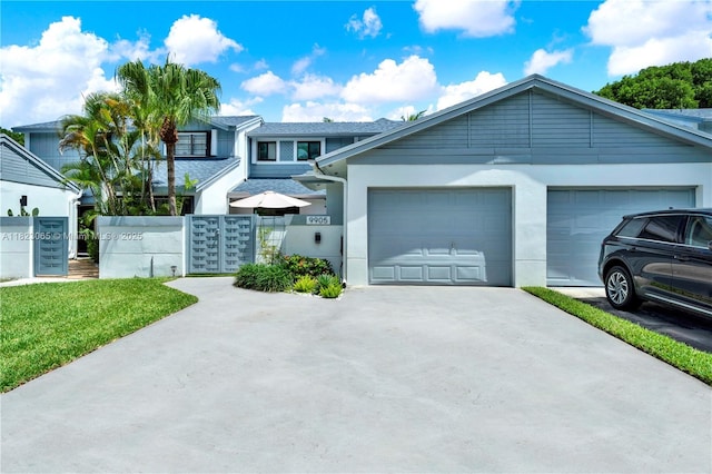 9905 NW 52nd Ln, Doral, FL 33178 - view of front of property featuring concrete driveway, a garage, and stucco siding
