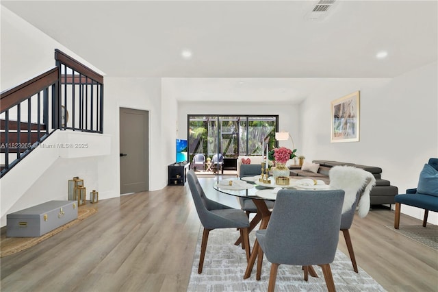 9905 NW 52nd Ln, Doral, FL 33178 - dining space featuring wood finished floors, stairs, and recessed lighting