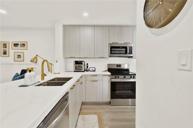 9905 NW 52nd Ln, Doral, FL 33178 - kitchen featuring stainless steel appliances, light wood finished floors, light stone countertops, modern cabinets, and recessed lighting