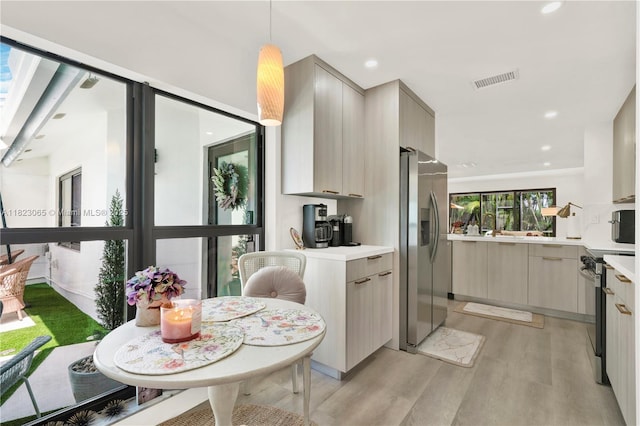 9905 NW 52nd Ln, Doral, FL 33178 - kitchen featuring stainless steel appliances, light wood finished floors, modern cabinets, light countertops, and recessed lighting