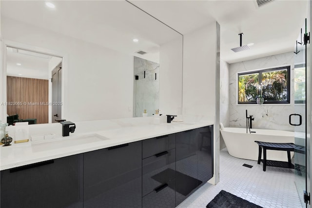 9905 NW 52nd Ln, Doral, FL 33178 - bathroom featuring double vanity, a freestanding bath, a marble finish shower, recessed lighting, and tile patterned floors