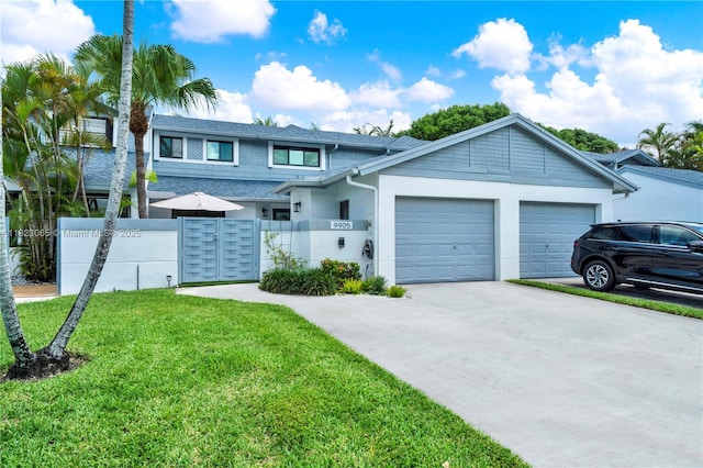 9905 NW 52nd Ln, Doral, FL 33178 - view of front of home featuring a garage, driveway, stucco siding, and roof with shingles
