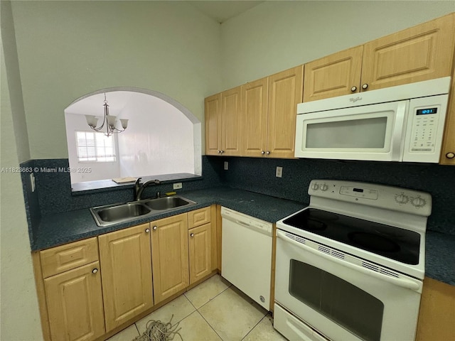 1250 SE 28th Ct Unit 203, Homestead, FL 33035 - kitchen with white appliances, dark countertops, a chandelier, and light tile patterned flooring