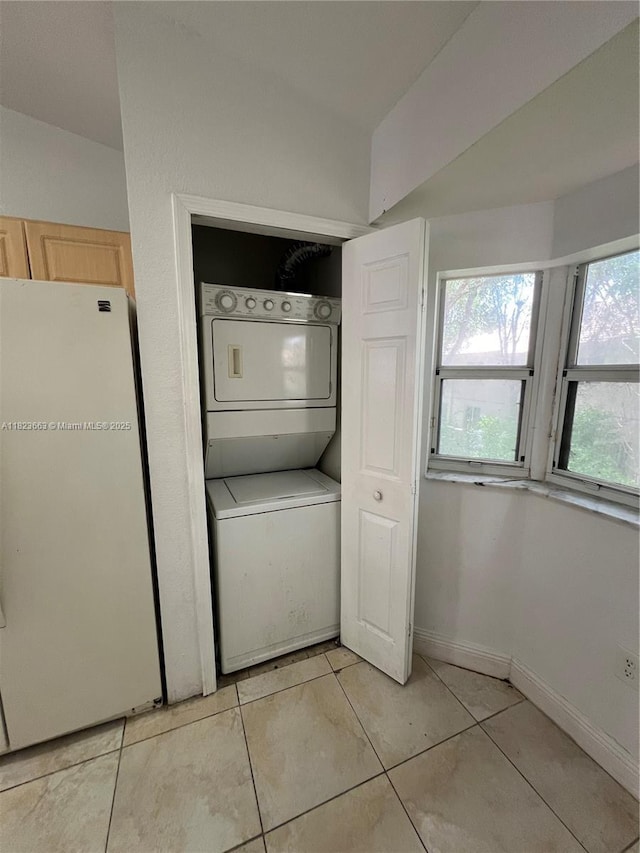 1250 SE 28th Ct Unit 203, Homestead, FL 33035 - laundry room featuring stacked washer / drying machine and light tile patterned floors