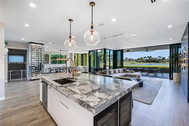 450 W 62nd St, Miami Beach, FL 33140 - kitchen with open floor plan, an island with sink, modern cabinets, hanging light fixtures, and recessed lighting