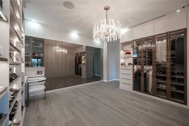 450 W 62nd St, Miami Beach, FL 33140 - spacious closet with a chandelier and light wood-style floors