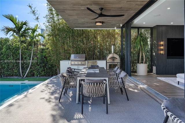 450 W 62nd St, Miami Beach, FL 33140 - view of patio featuring exterior kitchen, outdoor dining space, and a ceiling fan