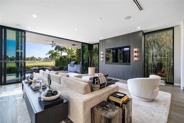 450 W 62nd St, Miami Beach, FL 33140 - living area with floor to ceiling windows, plenty of natural light, recessed lighting, wood finished floors, and wooden walls