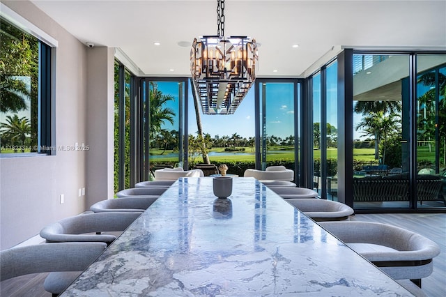 450 W 62nd St, Miami Beach, FL 33140 - dining room featuring a wall of windows, a chandelier, wood finished floors, and recessed lighting