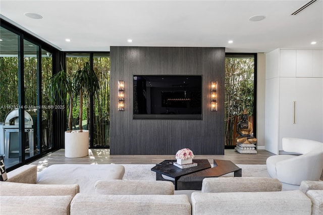 450 W 62nd St, Miami Beach, FL 33140 - living area with wood finished floors, a wall of windows, and recessed lighting