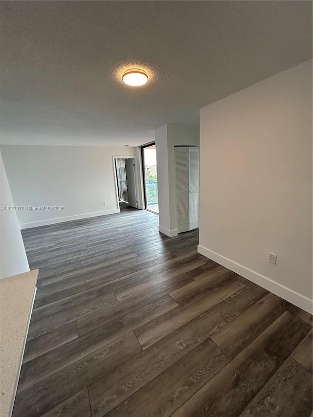 11800 SW 18th St Unit 527-4, Miami, FL 33175 - empty room featuring dark wood-style flooring and baseboards