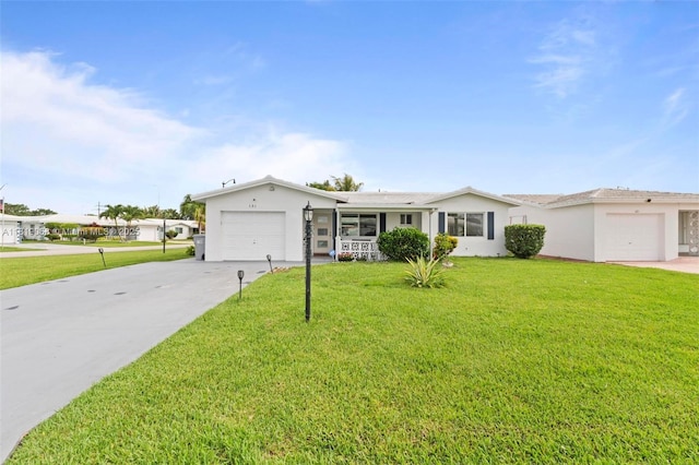 131 NW 31st Ct, Pompano Beach, FL 33064 - single story home with an attached garage, concrete driveway, a front lawn, and stucco siding