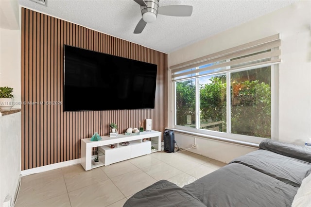 131 NW 31st Ct, Pompano Beach, FL 33064 - tiled living room featuring a ceiling fan, a textured ceiling, and an accent wall