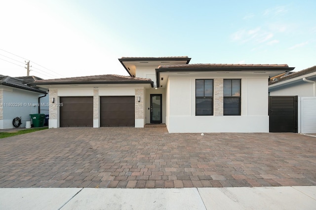 14659 SW 23rd Ter, Miami, FL 33175 - prairie-style home featuring a garage, stucco siding, a tiled roof, and decorative driveway