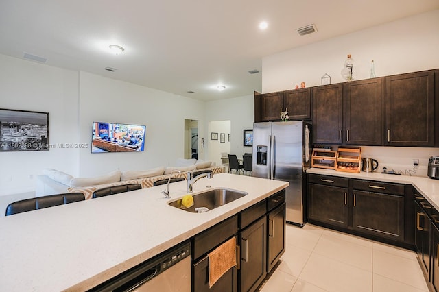14659 SW 23rd Ter, Miami, FL 33175 - kitchen with appliances with stainless steel finishes, open floor plan, light countertops, light tile patterned flooring, and dark brown cabinetry