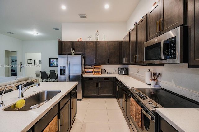 14659 SW 23rd Ter, Miami, FL 33175 - kitchen with appliances with stainless steel finishes, light tile patterned flooring, dark brown cabinetry, and open floor plan