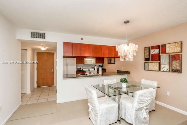 1200 Brickell Bay Dr Unit 1518, Miami, FL 33131 - dining room featuring a chandelier and baseboards