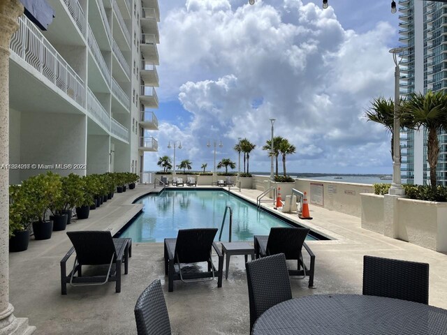 1200 Brickell Bay Dr Unit 1518, Miami, FL 33131 - community pool with a water view and a patio area