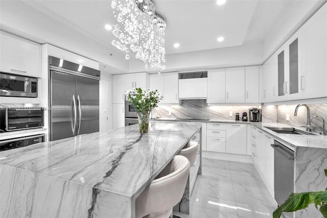 333 Las Olas Way Unit 804, Fort Lauderdale, FL 33301 - kitchen with built in appliances, recessed lighting, light stone counters, white cabinets, and glass insert cabinets