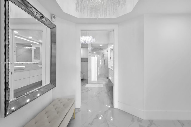 333 Las Olas Way Unit 804, Fort Lauderdale, FL 33301 - corridor with a chandelier and marble tiled floors