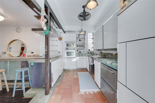 305 Jefferson Ave Unit 5, Miami Beach, FL 33139 - kitchen with white appliances, white cabinetry, open shelves, and hanging light fixtures