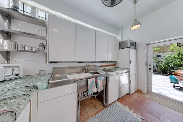 305 Jefferson Ave Unit 5, Miami Beach, FL 33139 - kitchen with plenty of natural light, white cabinetry, and light countertops
