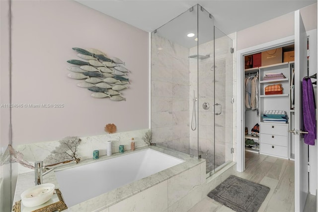 480 NE 31st St Unit 4804, Miami, FL 33137 - bathroom featuring a bath, a shower stall, and a walk in closet