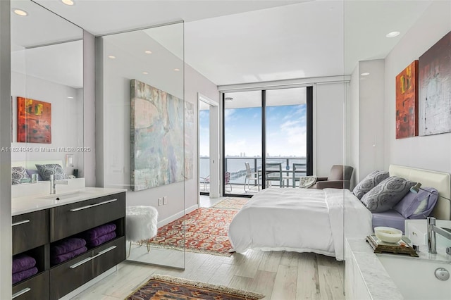 480 NE 31st St Unit 4804, Miami, FL 33137 - bedroom featuring floor to ceiling windows, access to exterior, light wood finished floors, a water view, and recessed lighting