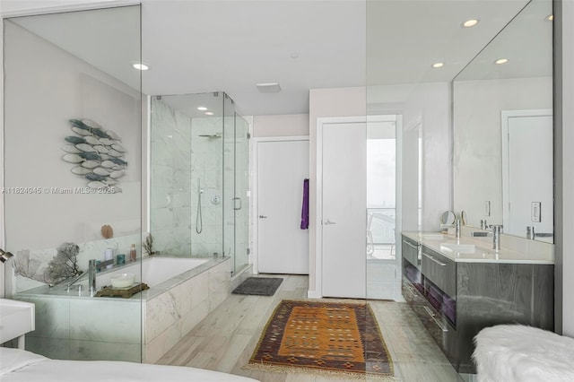 480 NE 31st St Unit 4804, Miami, FL 33137 - full bathroom with a bath, a stall shower, double vanity, recessed lighting, and wood finished floors