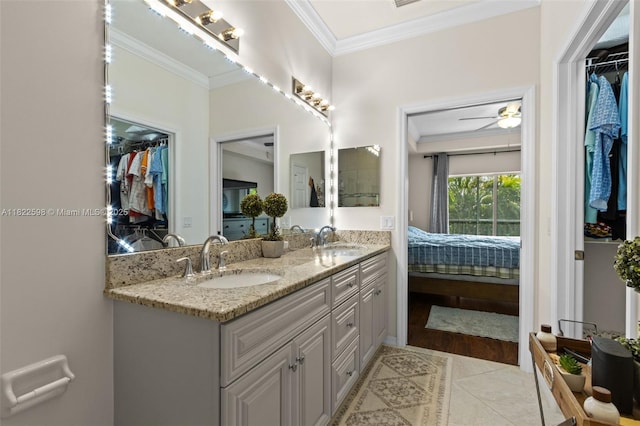 1051 Winding Pinces Cir Unit 203, Cape Coral, FL 33909 - bathroom featuring double vanity, ornamental molding, ensuite bath, tile patterned flooring, and a spacious closet