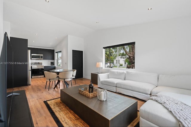 309 SE 3rd Ave, Hallandale Beach, FL 33009 - living room with vaulted ceiling, light wood-type flooring, and recessed lighting