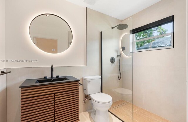 309 SE 3rd Ave, Hallandale Beach, FL 33009 - bathroom featuring a walk in shower, vanity, and tile patterned flooring