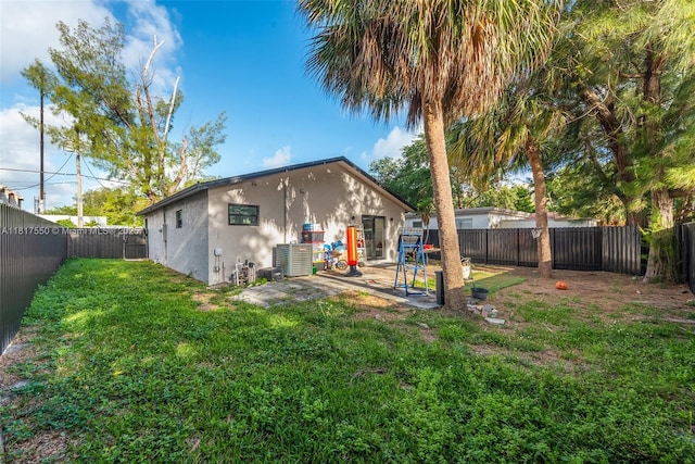 309 SE 3rd Ave, Hallandale Beach, FL 33009 - back of house featuring a fenced backyard, a patio area, and stucco siding