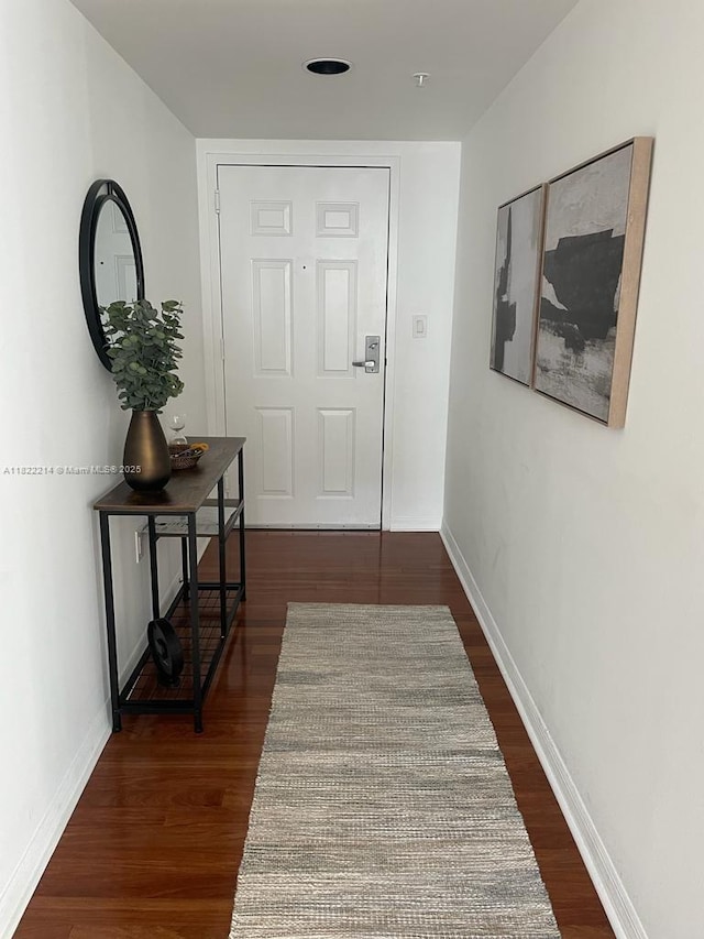 1155 Brickell Bay Dr, Miami, FL 33131 - hallway featuring dark wood-style floors and baseboards