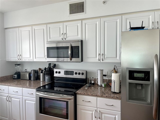 1155 Brickell Bay Dr, Miami, FL 33131 - kitchen with stainless steel appliances and white cabinets