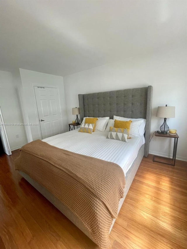 1155 Brickell Bay Dr, Miami, FL 33131 - bedroom with light wood-type flooring and baseboards