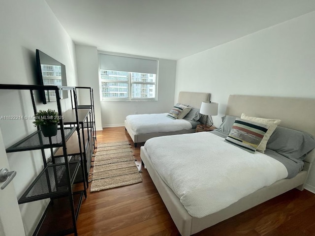 1155 Brickell Bay Dr, Miami, FL 33131 - bedroom featuring dark wood-type flooring and baseboards