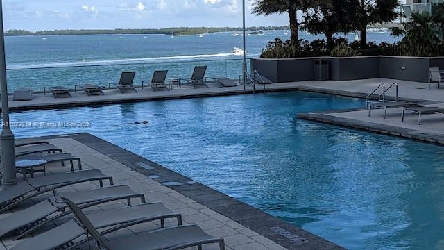 1155 Brickell Bay Dr, Miami, FL 33131 - community pool featuring a patio and a water view