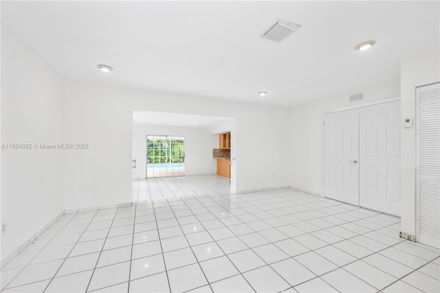 30 E 52nd Pl, Hialeah, FL 33013 - empty room with light tile patterned floors and recessed lighting