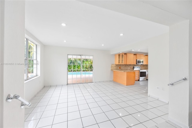 30 E 52nd Pl, Hialeah, FL 33013 - kitchen with stainless steel appliances, light countertops, backsplash, open floor plan, and recessed lighting