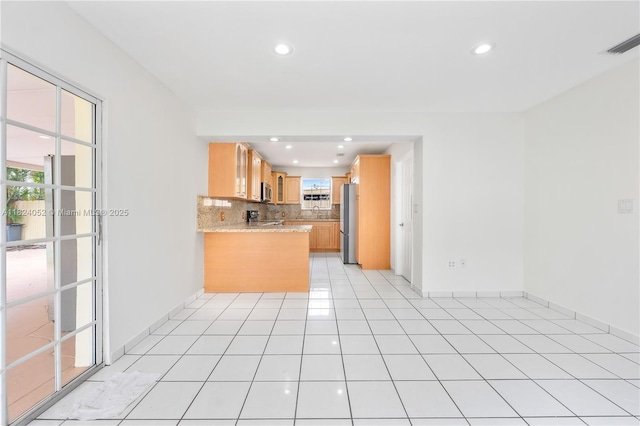 30 E 52nd Pl, Hialeah, FL 33013 - kitchen with appliances with stainless steel finishes, healthy amount of natural light, recessed lighting, decorative backsplash, and a peninsula