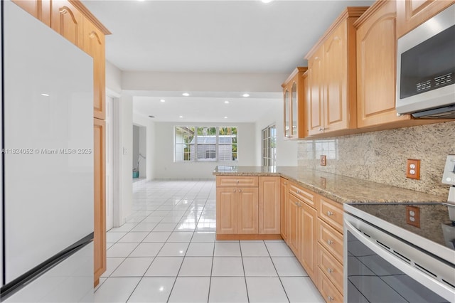 30 E 52nd Pl, Hialeah, FL 33013 - kitchen featuring stainless steel microwave, electric range oven, light brown cabinetry, light tile patterned floors, and recessed lighting